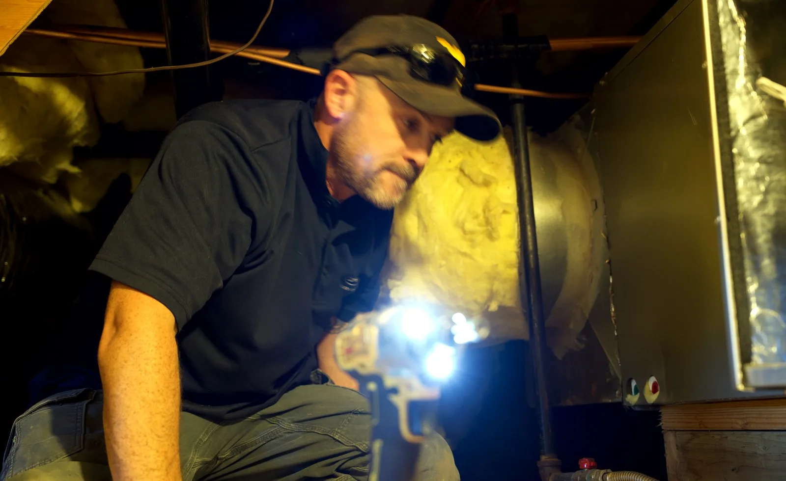 Brewer HVAC technician repairing an indoor furnace cabinet