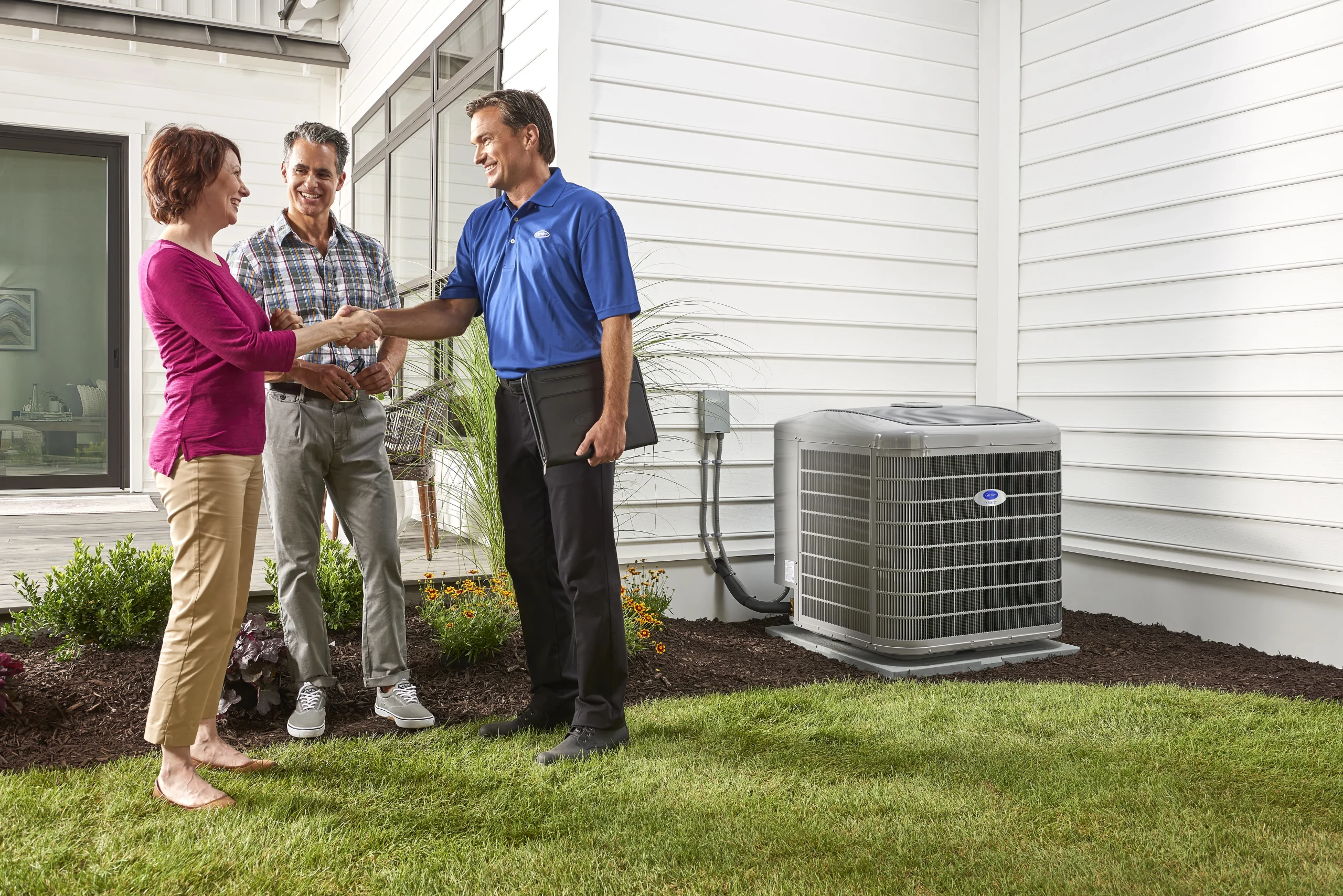 dealer outside shaking hands with couple