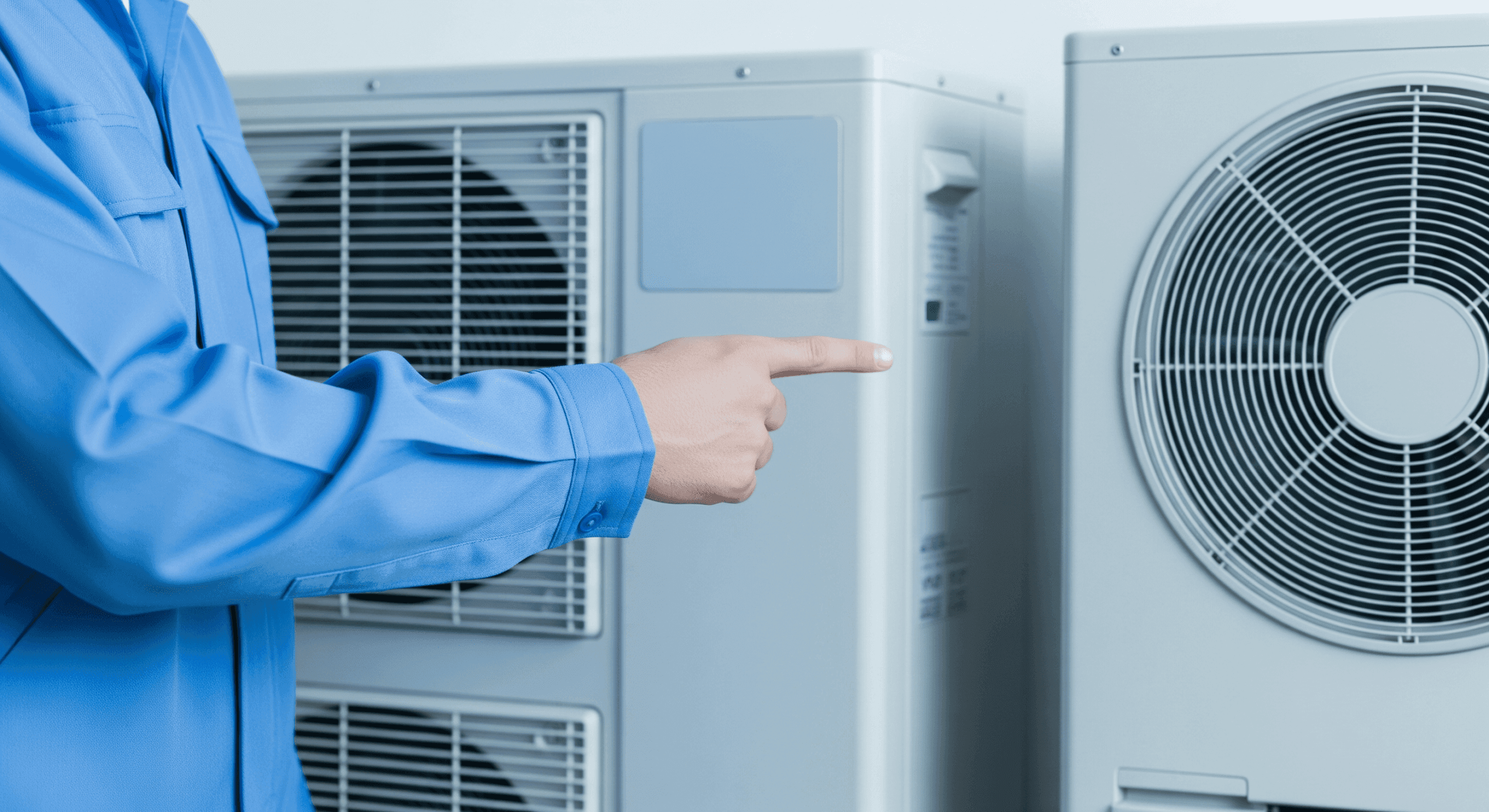 Professional pointing to AC units in showroom.