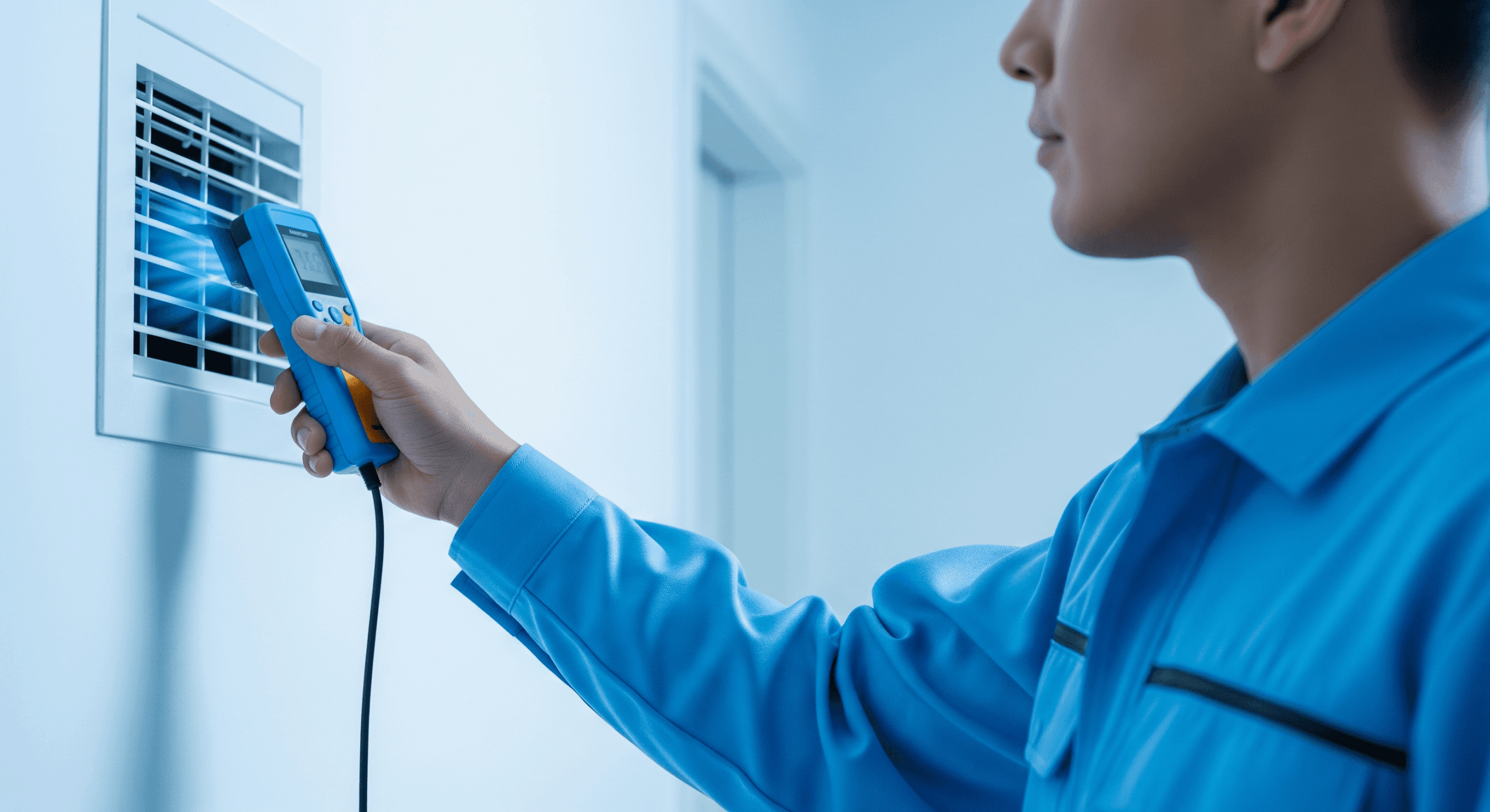 Technician checking airflow from a vent during HVAC sizing using Manual J calculation